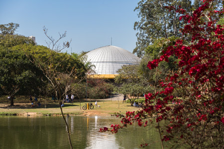 Sao Paulo, Brazil, August 6, 2016. Partial view of the Planetarium Ibirapuera Park by the lake with people in their Sunday leisure.のeditorial素材