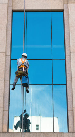 SÃ£o Paulo, Brazil, January 31, 2015. Worker cleaning windows of a commercial building on January 31, 2015 in Sao Paulo, Brazil.のeditorial素材