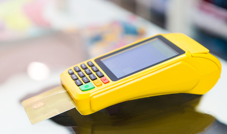 Credit card machine with bokeh background.の写真素材