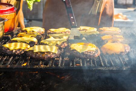 Hamburger being grilled over a wood fire.の写真素材