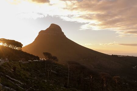 Lion's Head Mountain photographed during a sunset with a paraglider flying at high altitudes. Cape Town, South Africa.の写真素材