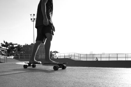 Boys practicing skateboarding during the sunset.の写真素材