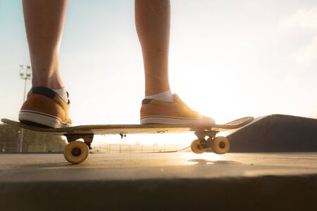 Boys practicing skateboarding during the sunset.の写真素材