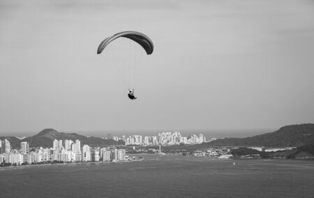 Paragliders flying over the city of Santos and Sao Vicente, Brazil.