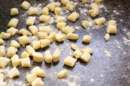 gnocchi being prepared to be cooked.の写真素材