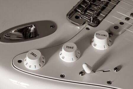 Electric guitar detail on a black background.