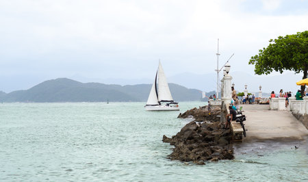 Santos, Brazil. February 07, 2021. Sailboat entering the port channel of the city of Santos while tourists enjoy the view of the city, Sao Paulo Brazil.のeditorial素材