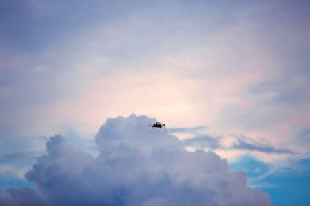 Drone doing aerial footage and in the background a sky with clouds.