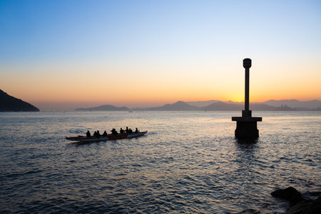 Group of Hawaiian canoe unidentifiable paddlers enjoying a beautiful afternoon in Santos, Brazil.の写真素材
