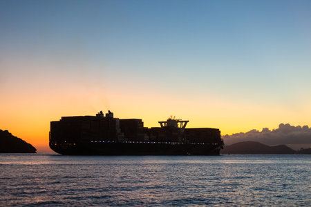 Container ship leaving the port of Santos during sunset.