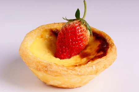 sweet egg tart and strawberry on it