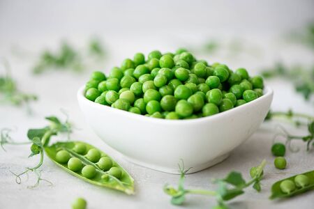 fresh green peas with greens and pea podsの写真素材