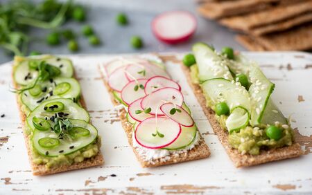 rye bread sandwiches with vegetables, cream cheese and sesame seeds