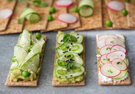 rye bread sandwiches with vegetables, cream cheese and sesame seedsの写真素材