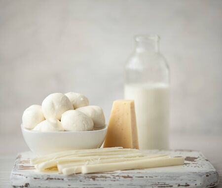 cheese plate of three types of cheese with milk