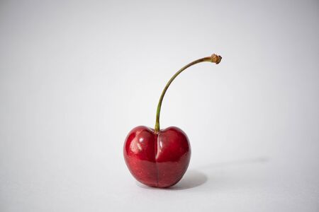 ripe large sweet cherry on a white backgroundの写真素材