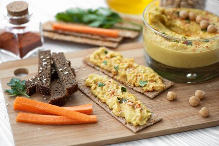 chickpeas hummus with herbs and spices in glass jarの写真素材