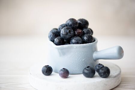 fresh large blueberries in a blue dipper