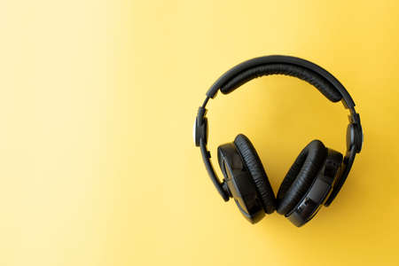 black music headphones on yellow backgroundの写真素材