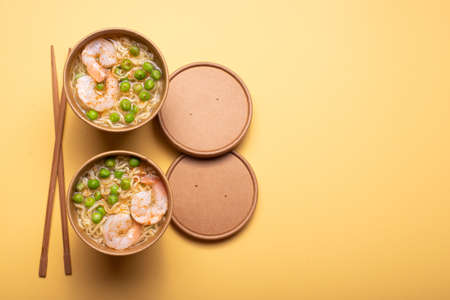 Chinese noodles with shrimps and vegetables in a craft cup, top viewの写真素材
