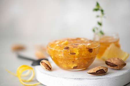 jam of tangerines and lemons with almonds in a glass jar