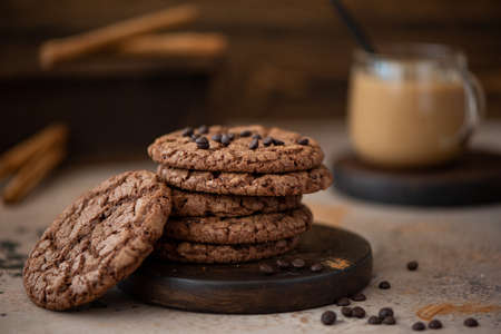 round chocolate chip cookies with almonds on a wooden table