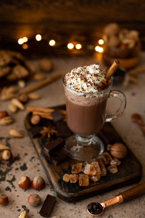 hot chocolate cocoa with whipped cream and grated chocolate in a glass mug