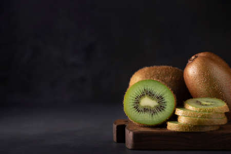 large ripe kiwi on a wooden board, close-upの写真素材