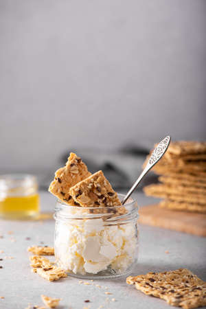whole grain crisps with curd cheese, close-up