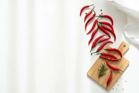 red hot pepper on a wooden board, top viewの写真素材