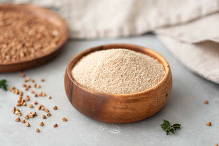 gluten-free homemade buckwheat flour in a wooden bowlの写真素材