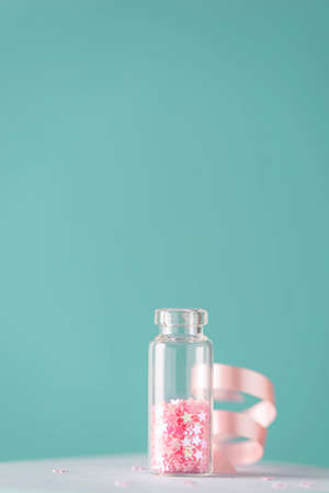 star confetti for decorating gifts in a glass bottle, close-upの写真素材