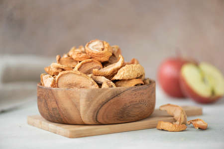 red apple dried slices in a wooden bowl, close-up