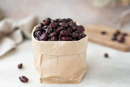 dried berries of large wild roses in a craft bag, close-upの写真素材
