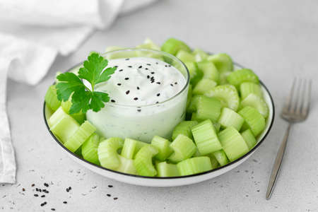chopped celery stalks with greek yogurt, close-upの写真素材