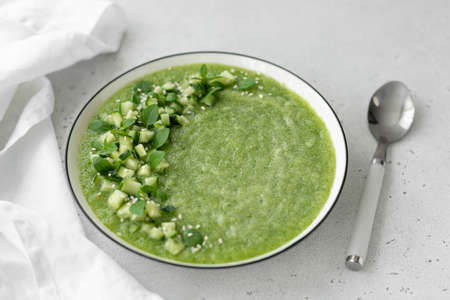 chilled cucumber gazpacho with herbs and spices in a white plate, close-upの写真素材
