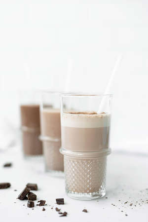 three glasses with chocolate milkshakes, close-upの写真素材