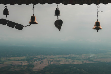 bell hanging on the roof of the temple with the view of the valley