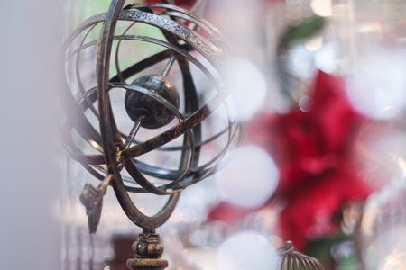 Antique metal globe on the background of the Christmas tree. Selective focus.