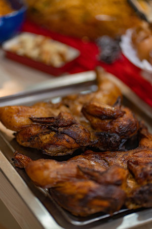Roasted chicken on a metal tray, close-up, selective focus