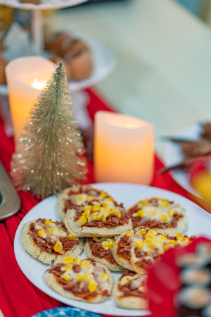 Christmas table setting with christmas tree and cookies. Selective focus.