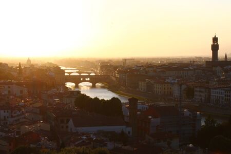 Sunset behind Ponte Vecchio in Florence in Italyの写真素材