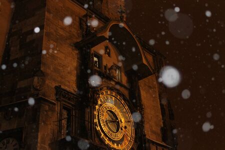 The snow and the golden clock in Prague