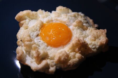 The whipped fried egg on a blue dishの写真素材