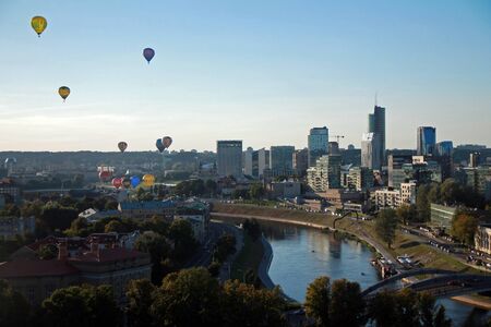Hot air balloons flying over Vilnius riverの写真素材