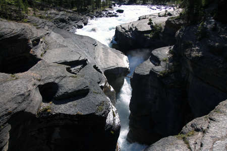 Foamy waterfalls of the river through the Mistaya Canyon in Banff National Park in Canadaの写真素材