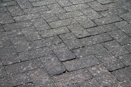 Crystals of salt to prevent the ice on a concrete pavement in a outdoors walkaway during winterの写真素材