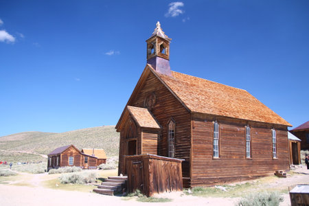 The brown abandoned ghost church of Bodie with the blue sky on the background in Californiaの写真素材