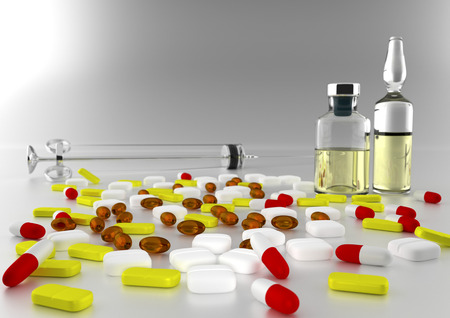 The glass syringe and two bottles of medicine on a white background surrounded by tabletsの写真素材