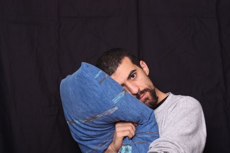 sleepy man with his pillowの写真素材